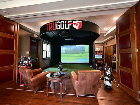Luxurious golf simulator lounge at Preserve Resort & Spa, complete with TRUGOLF system.